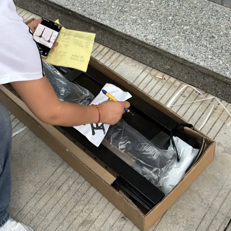 Opened carton with the product, the order list and a phone for the photo and video report